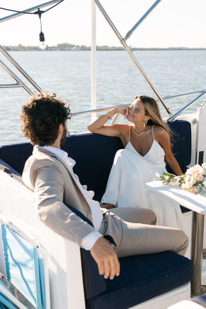 The bride and groom lovingly gaze at each other, surrounded by the serene beauty of their West Palm Beach Boat Elopement.