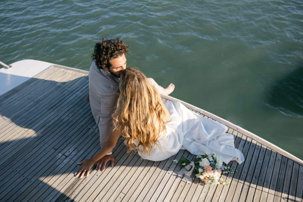 A serene portrait of the couple gazing into each other's eyes as the sun dips below the horizon, showcasing their West Palm Beach Boat Elopement.