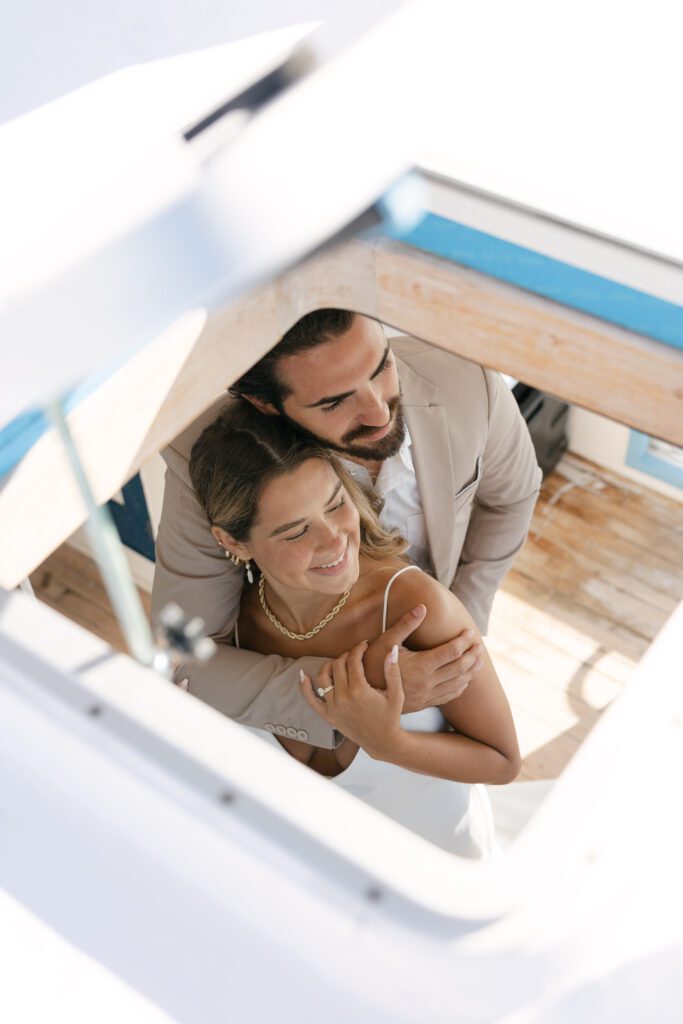 A romantic moment captured as the couple promises forever on the deck of the boat during their West Palm Beach Boat Elopement.