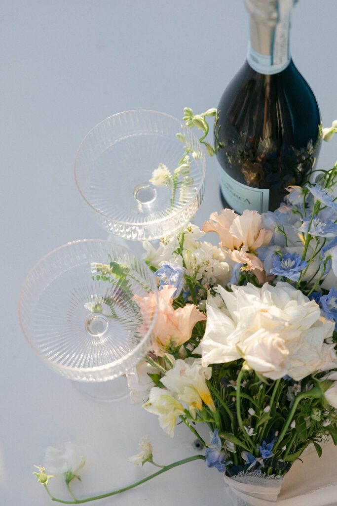 Close-up of the bride and groom champagne glasses and bouquet in West Palm Beach.