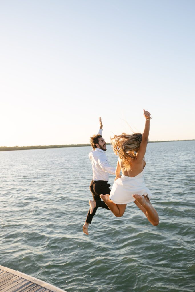 A playful moment captured as the couple dives into the water, celebrating their West Palm Beach Boat Elopement.