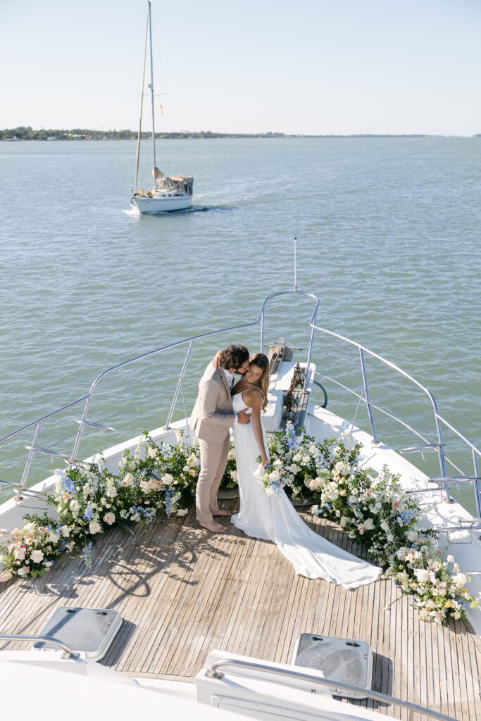 A wide shot of the couple exchanging vows on the yacht deck, highlighting the beauty of the ocean for their West Palm Beach Boat Elopement.