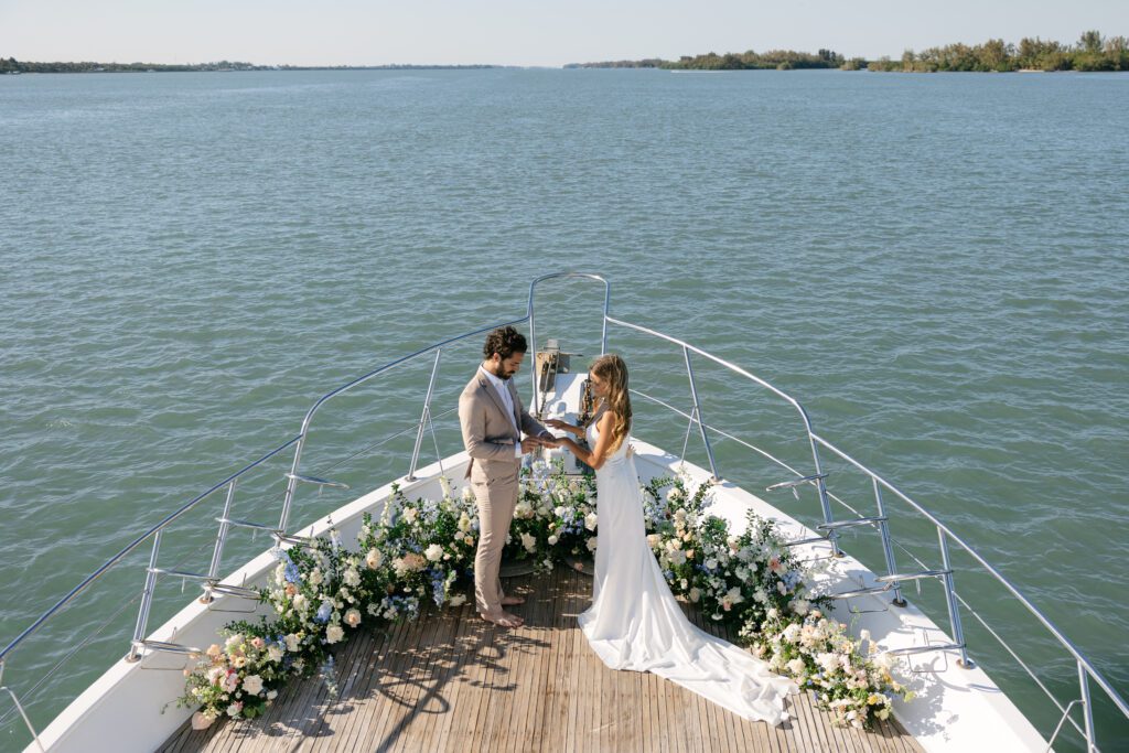 Bride and groom exchanging vows during their West Palm Beach boat elopement, surrounded by scenic views.