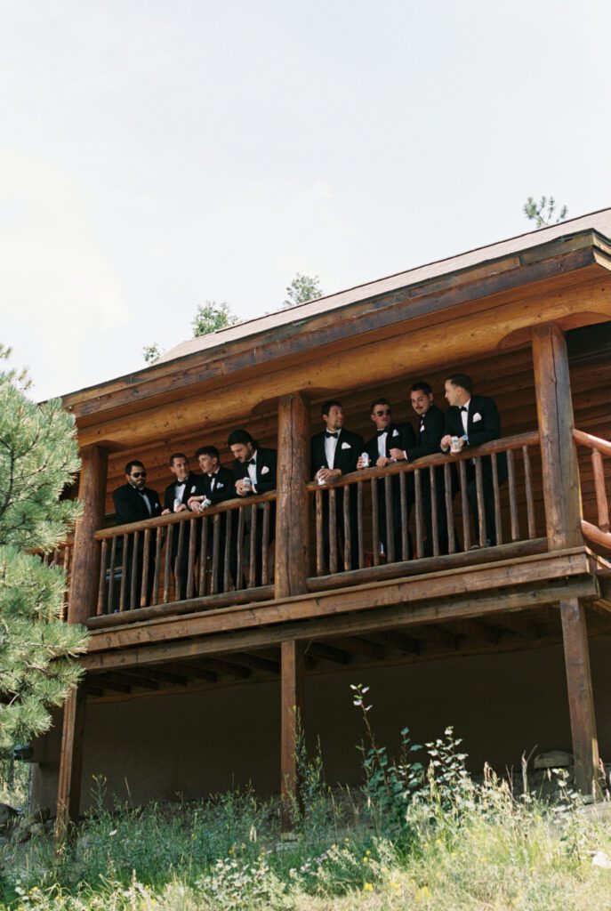 Groomsmen hanging out in cabin at Mt. Princeton Hot Springs wedding venue