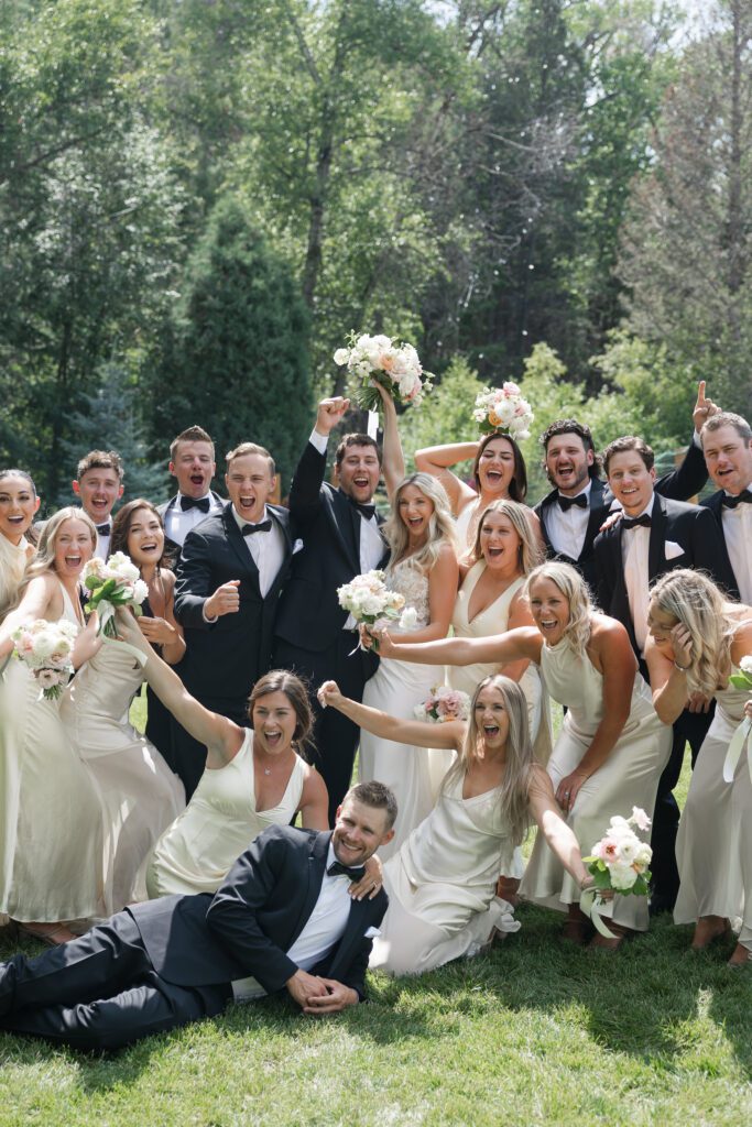 Wedding party smiling with Colorado mountains in the background at Mt. Princeton Hot Springs wedding